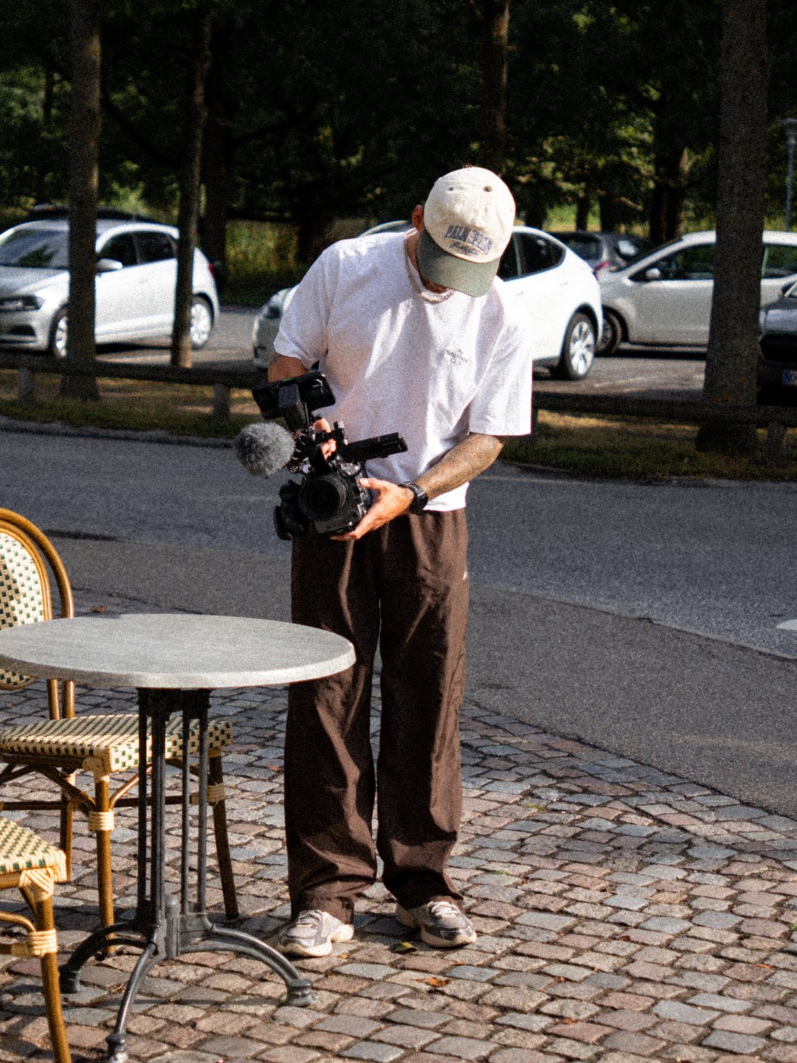 Filmmaker with a cinema camera on a cobbled square